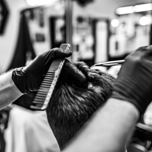 Haircut and hair styling. Black and white photo of a men's haircut.